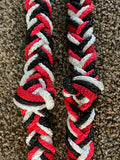 Extra thick and knotted, tri color of red, black and white barrel racing rein with snaps on the ends